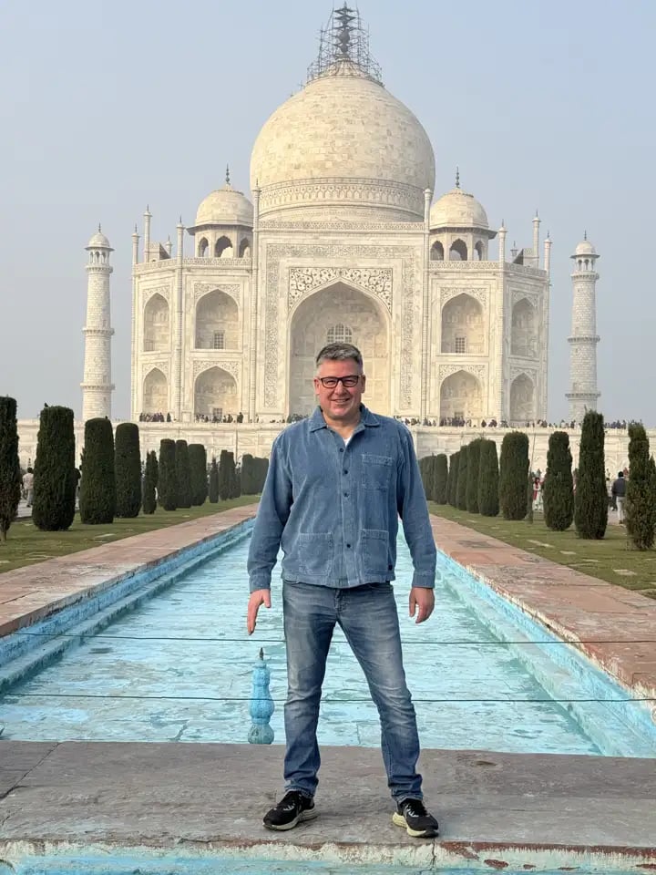 Martin standing in front of the Taj Mahal during his journey to India