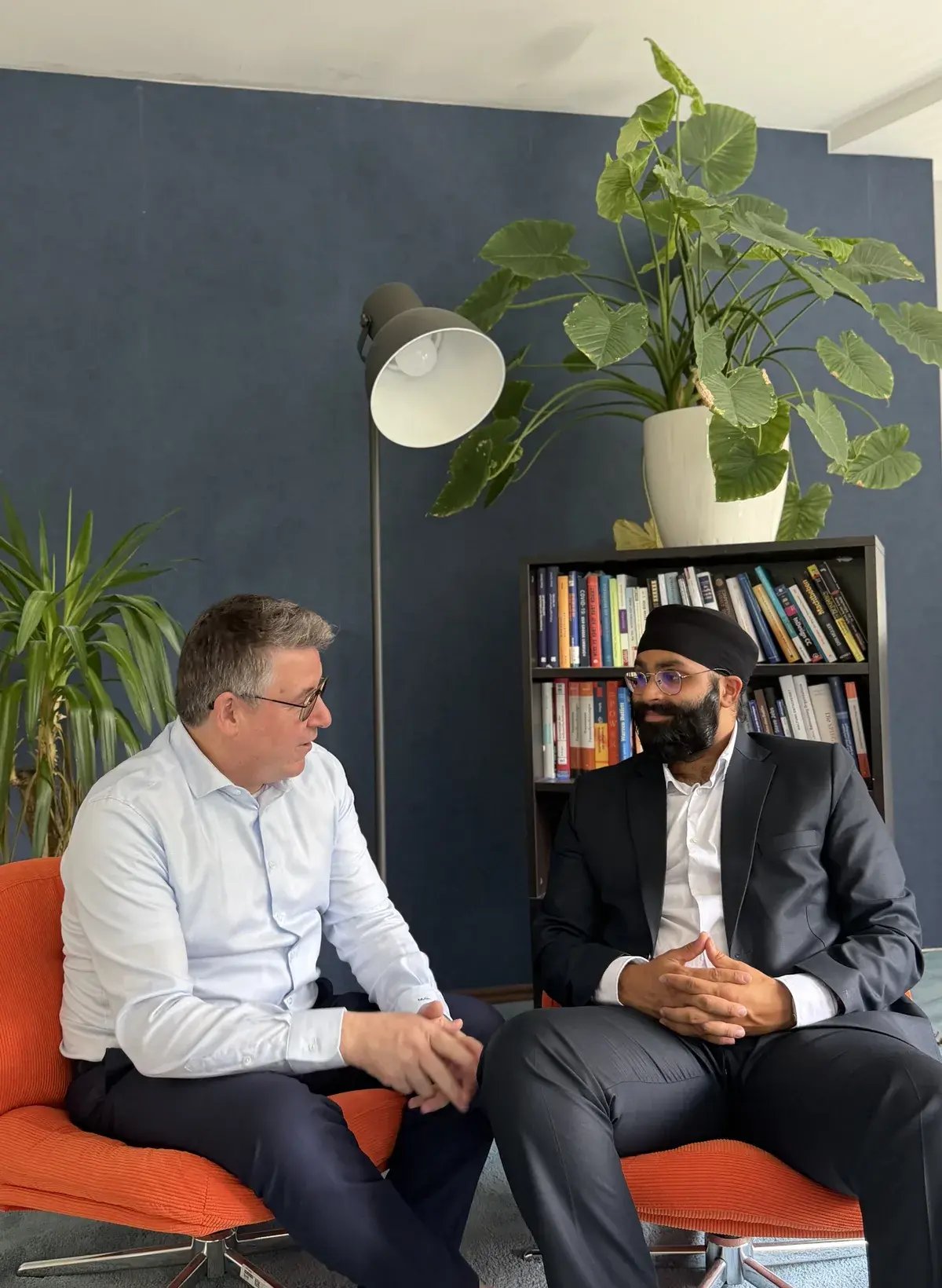 Mr Martin in conversation with Harpreet in the office