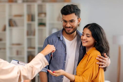 Couple receiving the keys to their new flat in Germany