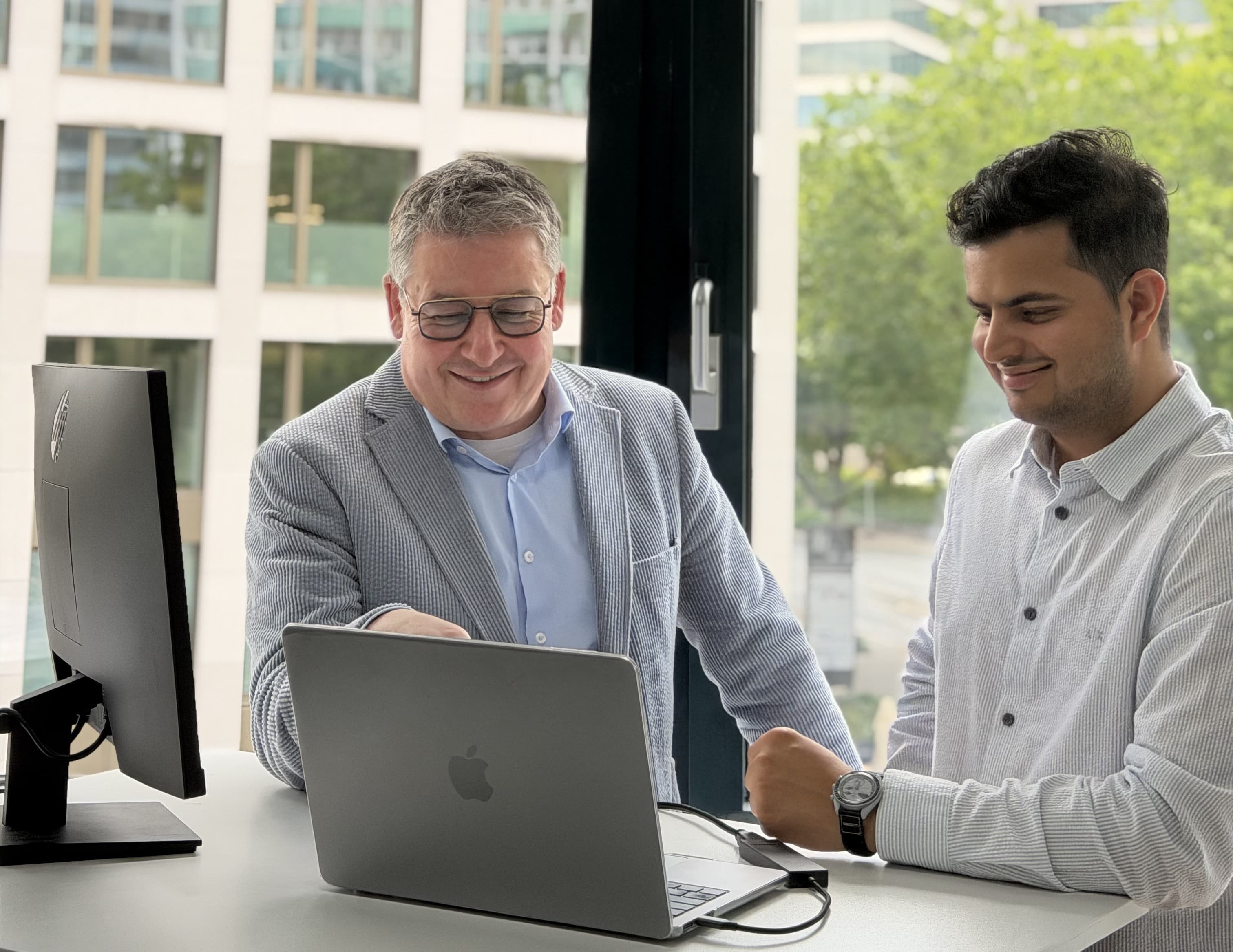 Martin and a NEOdirect adviser working together at a laptop in the office